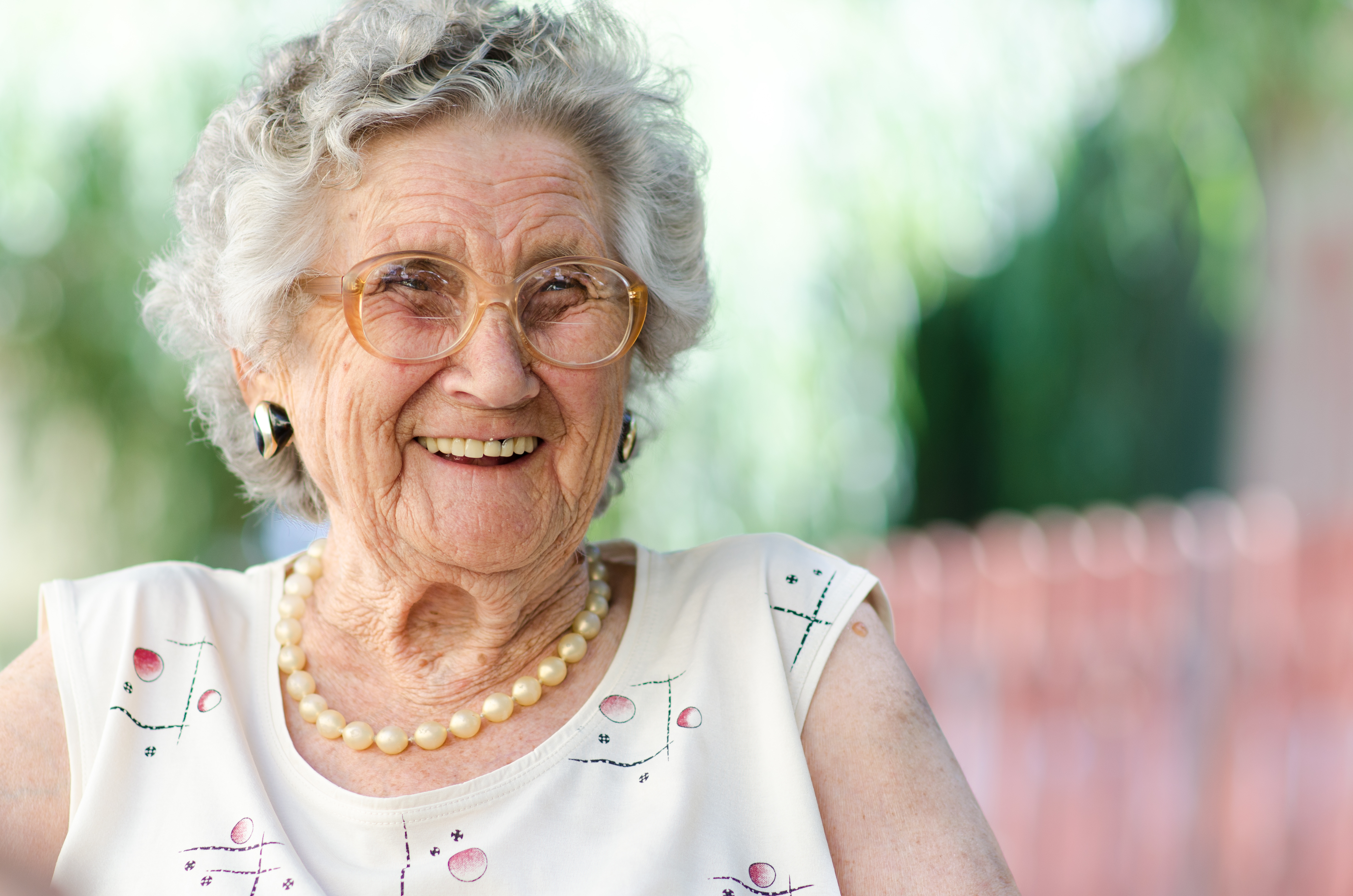 Older white woman wearing glasses and smiling