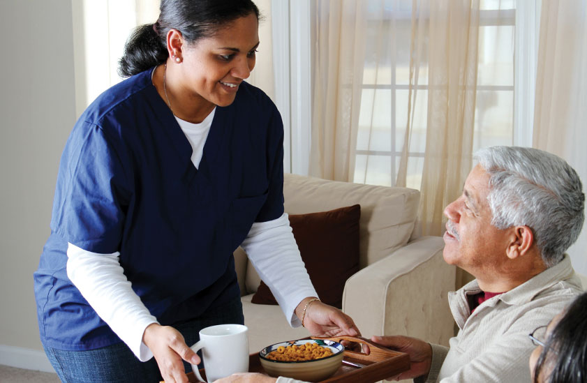 Nurse helping a man in his house